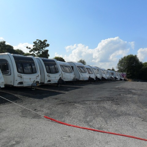 Rows of touring caravans lined up on the Whitfords Caravan Centre showground in Burnley